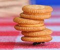 an and carrying three sandwich cookies